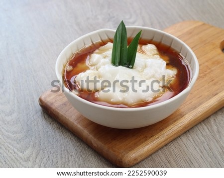 Rice Flour Coconut Milk Porridge served with brown sugar syrup. bubur sum sum or jenang sum sum. selected focus. isolated background  Royalty-Free Stock Photo #2252590039