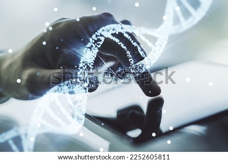 Creative DNA sketch and hand working with a digital tablet on background, biotechnology and genetic concept. Multiexposure