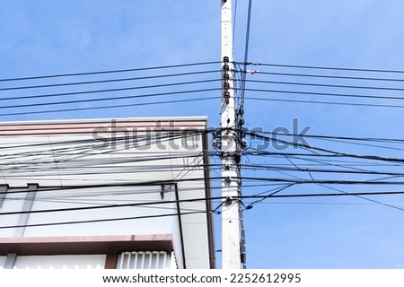 Electric pole with disorganized wires danger of high voltage against the blue sky pillars made of concrete Thailand