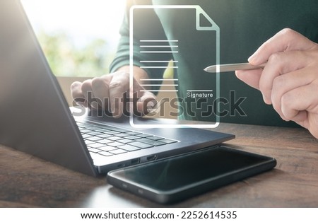 Electronic signature and paperless office. Businessman uses stylus pen to sign electronic documents or digital documents on virtual screen. E-signing. Technology and document management