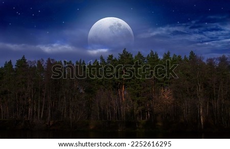 full moon over the forest near the river