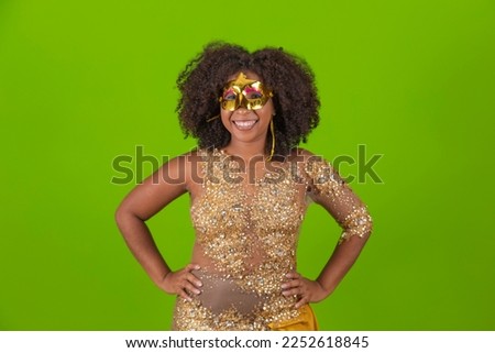 Brazilian afro woman posing in samba costume over green background with free space