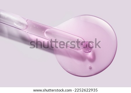Pipette fuchsia purple dropper serum oil texture sample swatch isolated on gray Royalty-Free Stock Photo #2252622935