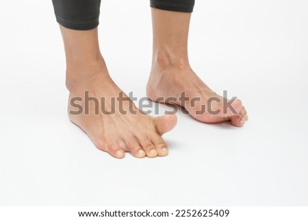 Lift big toe while keeping the other toes on the floor. Foot exercises for flexibility and mobility Royalty-Free Stock Photo #2252625409