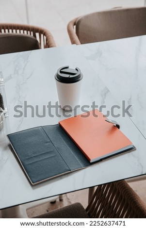 Notebook, Journal, blue diary add your own logo or text, mockup, coffee and table in a cafe 