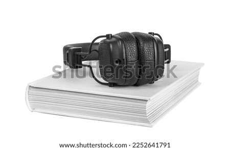 Audiobook concept. Audio book and wireless headphones isolated on white background. High quality photo