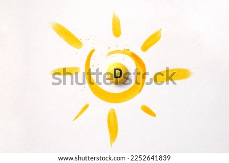 A tablet with the inscription Vitamin D in the center of the sun Royalty-Free Stock Photo #2252641839