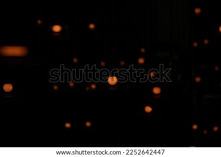 blur bokeh circus tube lamp hang from ceiling in dark room like firefly Royalty-Free Stock Photo #2252642447
