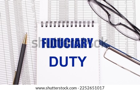 A white notepad with the text FIDUCIARY DUTY a pen, reports and glasses lie on a white office table. View from above