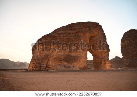 Set in golden desert sands and climbing three storeys into the Saudi Arabian sky is the awe-inspiring Elephant Rock, also known as Jabal AlFil Royalty-Free Stock Photo #2252670859