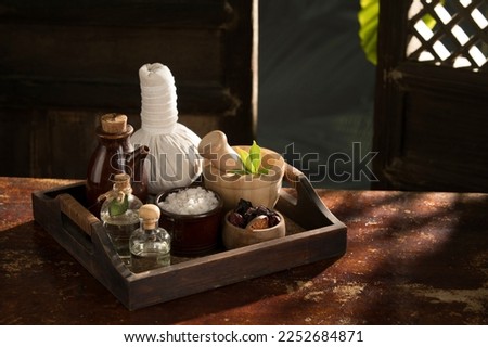 close up view of herb, salt, oil and Herbal Compress on color back. Royalty-Free Stock Photo #2252684871
