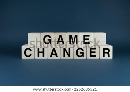 Game changer. Cubes form the word Game changer. Game changer business or political change concept and disruptive innovation