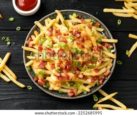Crispy French fries loaded with bacon, cheese sauce and spring onion Royalty-Free Stock Photo #2252685995