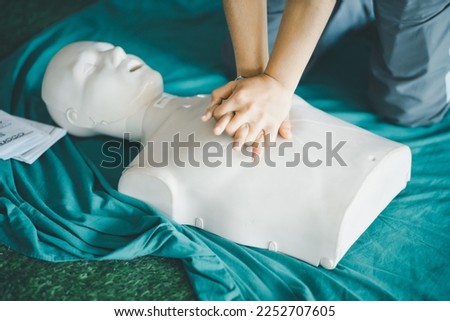 Demonstration of how to perform hands-on CPR on a plastic manikin for an effective experiment.
 Royalty-Free Stock Photo #2252707605