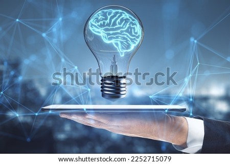 Close up of hand holding tablet with lamp, brain hologram and polygonal mesh on blurry city background. Brainstorm and inspiration concept. Double exposure