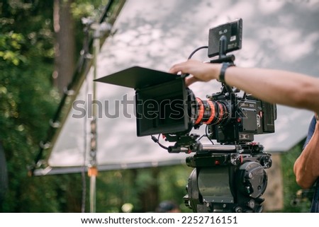 Professional cinema and video camera on the set. Shooting shift, lighting fixtures, shooting equipment and the team. Technique of modern filming and advertising. Royalty-Free Stock Photo #2252716151