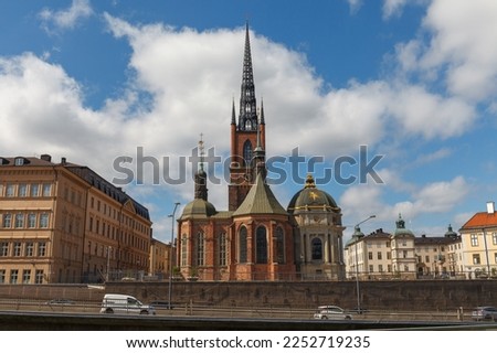 Stockholm, Sweden - June, 15, 2022: Riddarholmen Church and ornamented spire with scenic street view