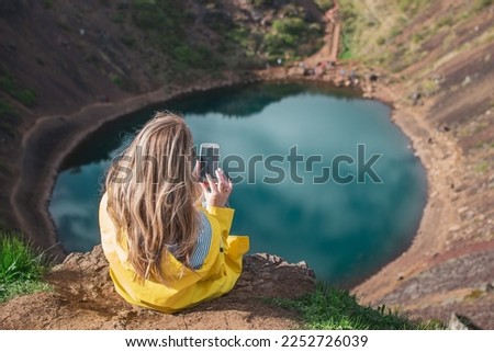 Kerid Crater in Iceland Sunny Day Golden Fall Woman in Yellow Coat