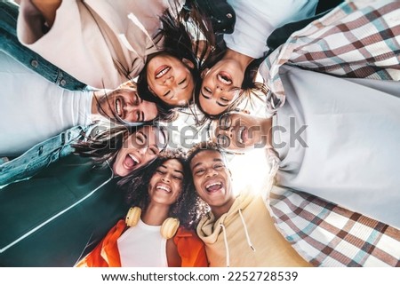 Multicultural community of young people smiling at camera outside - International university students taking selfie picture together - Friendship concept with guys and girls having fun on city street Royalty-Free Stock Photo #2252728539