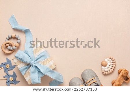 Baby shower, gender reveal, birthday party background with gift box and baby toys. Top view, flatlay, copy space Royalty-Free Stock Photo #2252737153