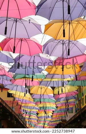 Colorful umbrellas on the street. Colorful umbrella screen background. Selective focus.
