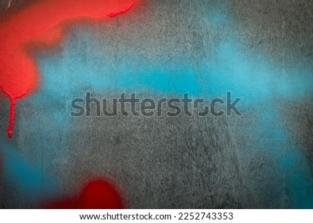 Fragment of the wall with blue red colors graffiti painting. Part of colorful street art graffiti on wall background