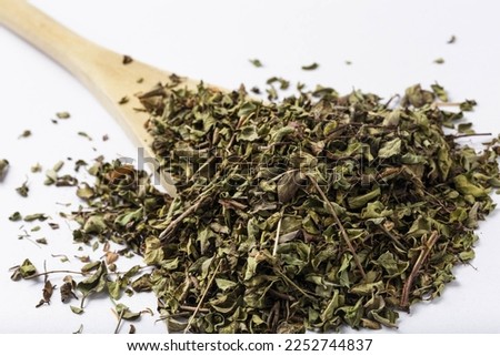 Dried thyme on a white background, creating a high-contrast image. Thyme is a popular herb used in cooking and its dried form is often used in seasoning dishes