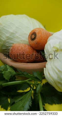 Assorted raw organic vegetables for soup on lime green background. Shot in selective focus, provided with copy space. Portrait mode.