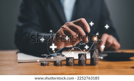 Interest rate and dividend concept, businessman calculating income and return on investment, save, income, return, retirement, compensation fund, investment, dividend tax, stock market, saving, trade. Royalty-Free Stock Photo #2252763185