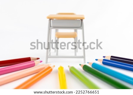 A study desk with colored pencils and toys. Art class image