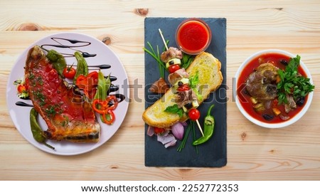 Image of tasty cooked different dishes from lamb with greens and vegetables at plate