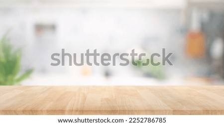 Selective focus.Wood table top on blur kitchen counter background.For montage product display or design key visual layout.