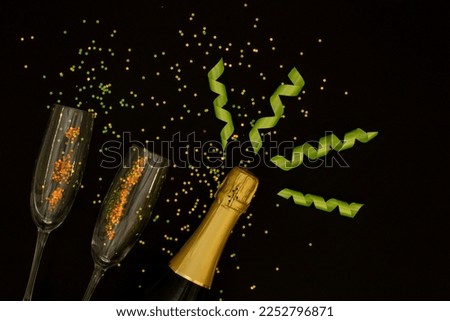 Champagne with party concept, Champagne bottle with glass and ribbon with confetti colorful stars.