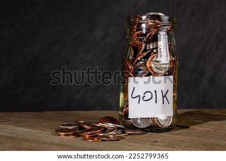 401k savings jar on a dark background. 