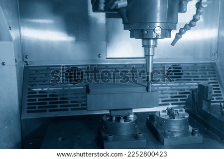The CNC milling machine rough cutting the graphite electrode parts with solid ball end mill. The mold and die manufacturing process by CNC machining center. Royalty-Free Stock Photo #2252800423