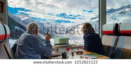 Man Points At Swiss Alps From The Glacier Express Royalty-Free Stock Photo #2252821123