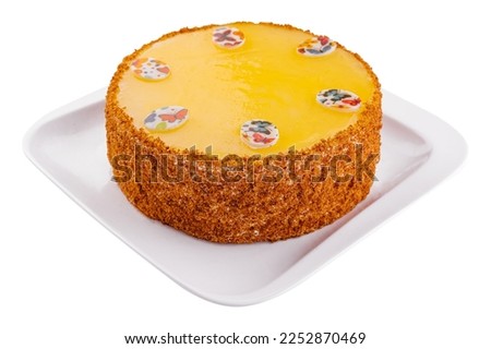 Carrot cake in yellow glaze on plate