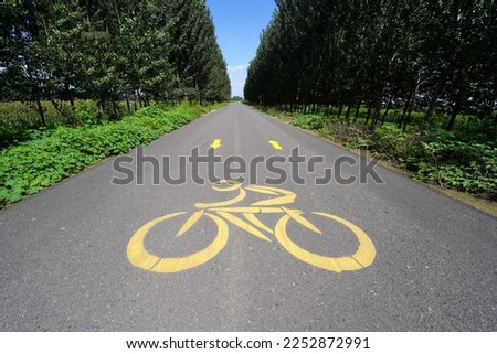 Bicycle lane signage on a street, Bicycle signage on asphalt pavement