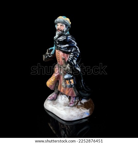 Porcelain figurine . antique figurine of a robber on a black isolated background. pirate statue