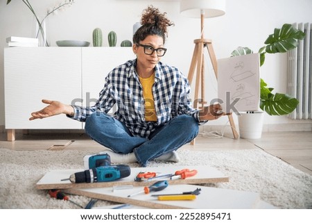  woman need help assembling furniture in new home Royalty-Free Stock Photo #2252895471