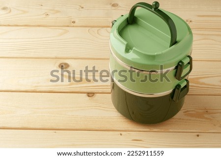 New empty plastic lunch box on a wooden background