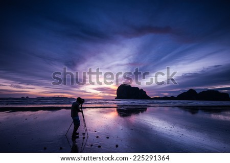 Silhouette of photographer on the beach, Pakmeng Beach, Trang, Thailand.