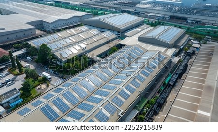 Top view Solar Cell on Warehouse Factory. Solar photo voltaic panels system power or Solar Cell on industrial building roof for producing green ecological electricity. Production of renewable energy. 
