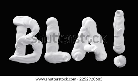 Bla bla, shaving foam letters on black background Royalty-Free Stock Photo #2252920685