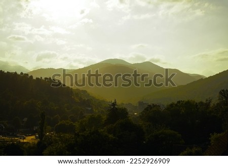 Beautiful mountain landscape with pine trees and mountain tops on a Sunny summer day. Dilijan, Armenia. Caucasian Mountains with summer forest.  National Park.