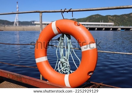 Lifebuoy on the stern in front of the dam