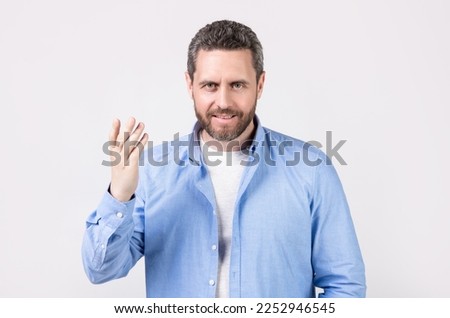 man gesturing with nonverbal gesture isolated on grey background. gesturing man Royalty-Free Stock Photo #2252946545