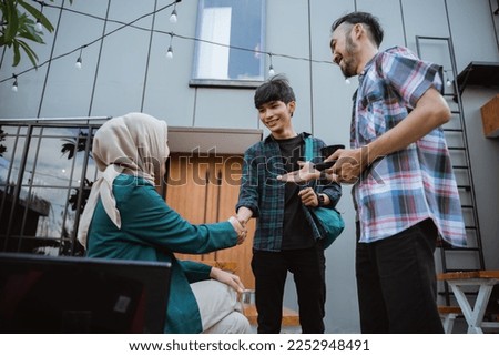 some asian students get acquainted by shaking hands while in front of the cafe Royalty-Free Stock Photo #2252948491