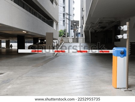 car park barrier with recoding CCTV camera, automatic entry system.