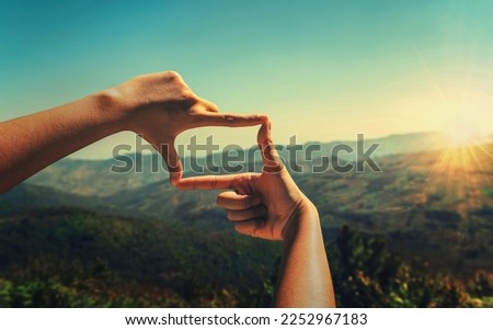 close up hand framing looking view sunrise Royalty-Free Stock Photo #2252967183